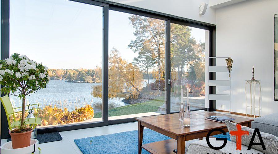 A beautiful view of a blue lake captured from the inside of a villa