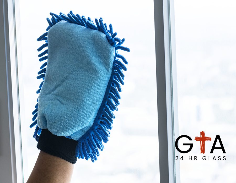 Closeup of hands cleaning window domestic chores concept