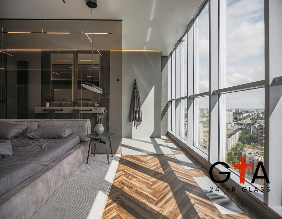 cool expensive interior design of room in prestigious luxury hotel with dark tones with modern LED lighting and stylish furniture. the area with a sink is separated by dark glass from the bedroom