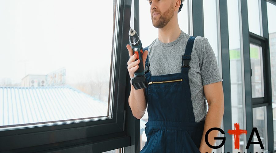 handsome young man installing bay window in new house construction site