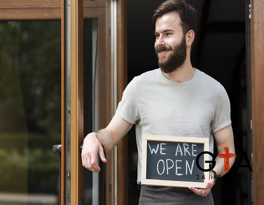 man-holding-we-are-open-sign