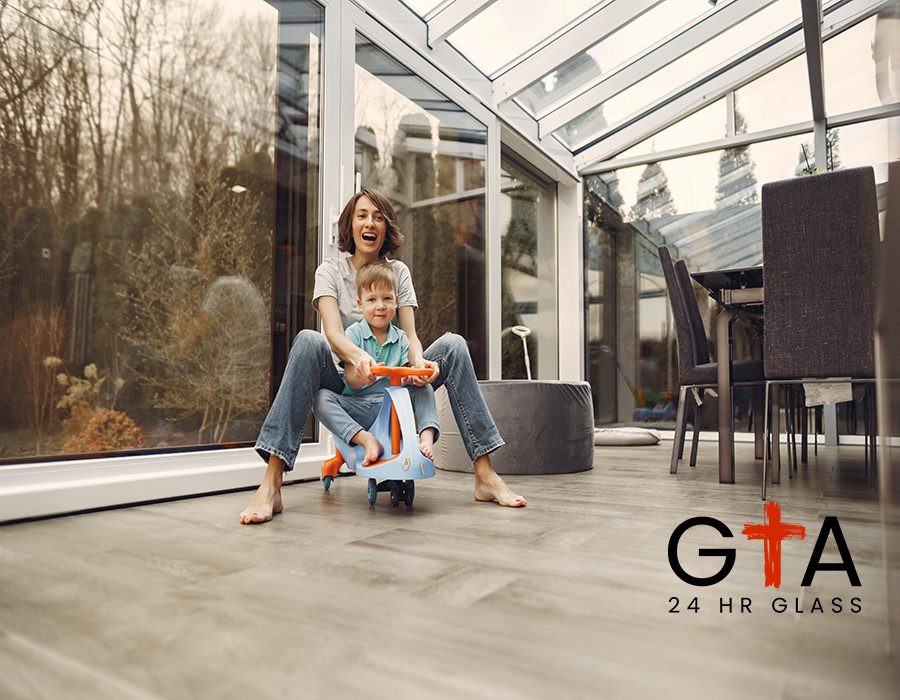 Beautiful woman with child. Woman in a gray t-shirt. Family go around the apartment on a toy car.