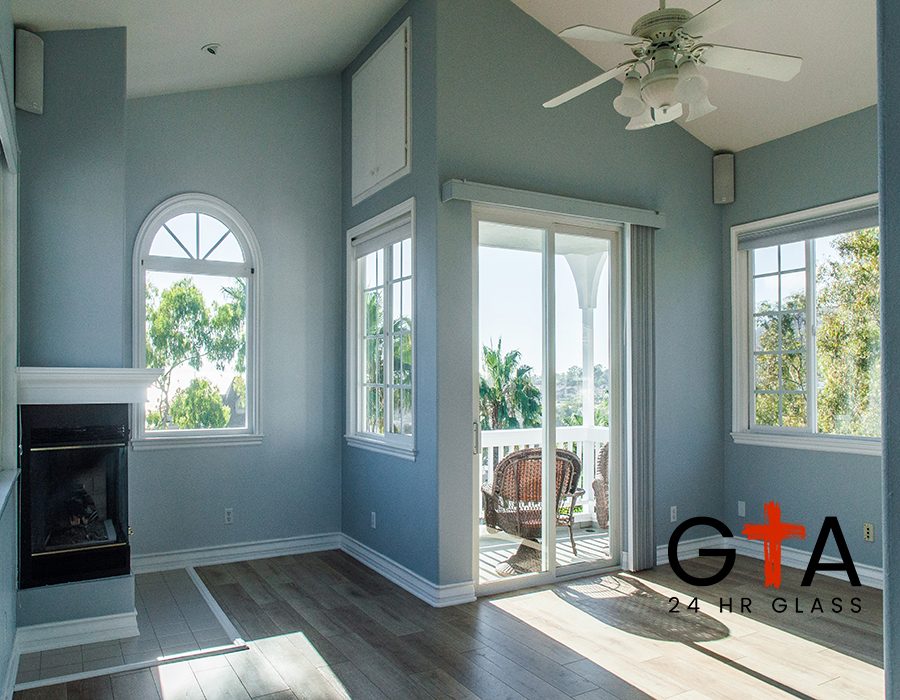 A trendy modern interior of a living room with blue walls and white windows