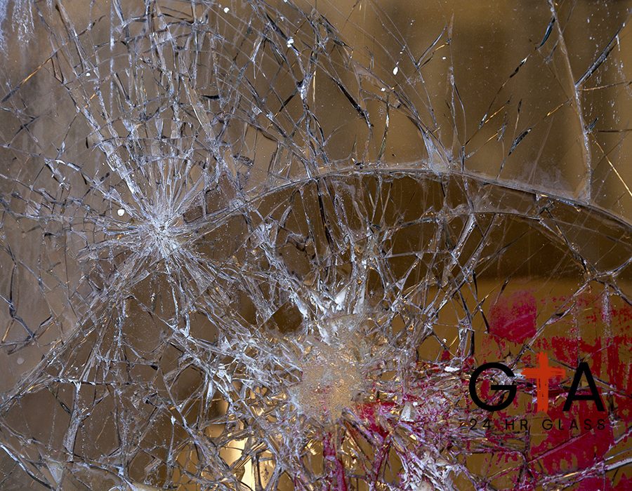 Close-up on a broken glass window after a vandalism.